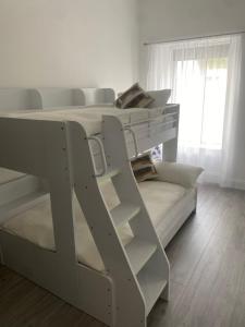 a white bunk bed in a room with a window at Carrick Gate in Carrick