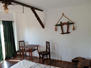 a room with two chairs and a table and a table and chairs at Cabana Alexa Tășnad in Tăşnad