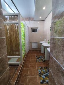 a bathroom with a shower and a sink at Urban Monkey Tent hostel & bar in Karakol +51 photos