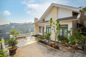 a house with a balcony with potted plants at Sen Đá Villa - Succulent Villa in Da Lat