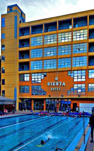 a large swimming pool in front of a building at New Siesta Hotel & Resort in Alexandria