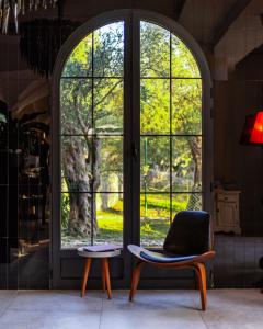 a room with an arched window and a chair at MASHTRA - The Olive House in Ulcinj