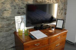 a wooden dresser with a television on top of it at El Terrat Sobre el Mercat in La Seu d'Urgell