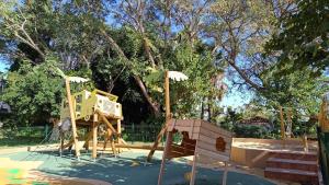 a playground in a park with a wooden play structure at Hotel Jardín Tecina in Playa de Santiago