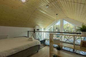 a bedroom with a bed and a large window at Oxigen Dream in Râşnov