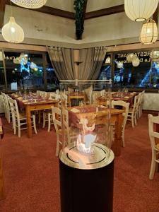 a display in a restaurant with tables and chairs at Hôtel Espace Montclar in Montclar