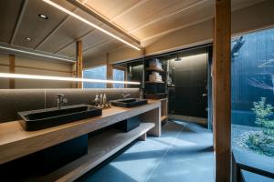 ein Badezimmer mit zwei Waschbecken und einer Dusche in der Unterkunft ANJIN Gosho Ebisugawa in Kyoto