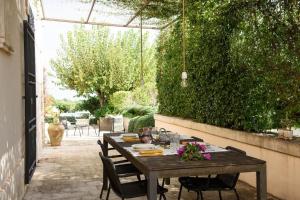 a wooden table and chairs in a patio at Tenuta La Moresca in Noto