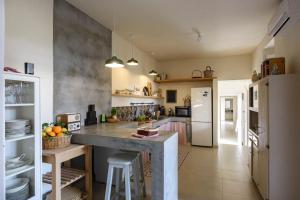 a kitchen with a large island in a room at Tenuta La Moresca in Noto