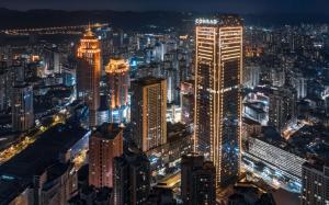 a view of a city at night at Conrad Chongqing in Chongqing
