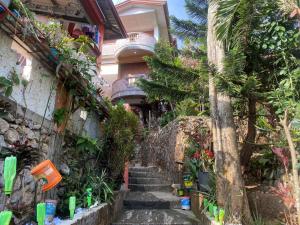 Baguio mountain villa view RW في باغيو: درج يؤدي الى منزل به نباتات