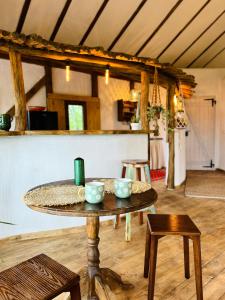 a table with bowls on it in a room at Inside, The Village- The Hut Studio in Tunari +38 photos