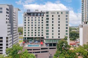 an aerial view of two tall buildings with a pool at Cambria Hotel Austin Downtown in Austin