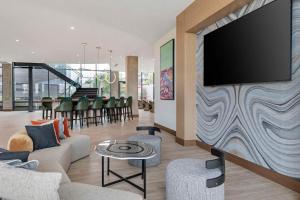 a living room with a flat screen tv on a wall at Cambria Hotel Austin Downtown in Austin