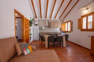 a living room with a couch and a table and a kitchen at Complejo Rural las Fuentes de Letur in Letur