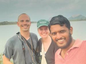 tre persone che posano per una foto davanti all'acqua di Sigiri Arana a Sigiriya