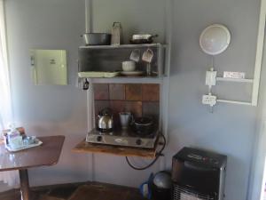 a kitchen with a stove with pots and pans at Marico Guest Lodge in Groot-Marico
