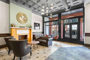 a living room with a couch and a fireplace at Tygart Hotel, Ascend Hotel Collection in Elkins