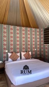 a bed in a tent with a run sign on it at Rum desert magic in Wadi Rum