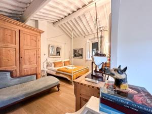 Una sala de estar con una cama y una mesa con una estatua de perro. en Residenza del Gallo - Residenze Tonnina Group, en Casale Marittimo