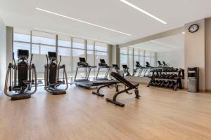 a gym with several treadmills and elliptical machines at Cambria Hotel Denver Downtown RiNo in Denver