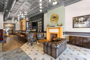 a bar with a couch and a fireplace at Tygart Hotel, Ascend Hotel Collection in Elkins