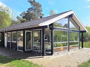 a house with large glass doors on a patio at 8 person holiday home in Hadsund in Hadsund