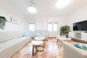 Sala de estar blanca con sofá y mesas en Cozy & beautiful villa, en Monreal de Ariza