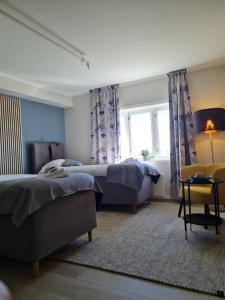 Voodi või voodid majutusasutuse Lofoten Værøy Bryggehotell AS toas