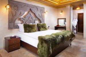 A bed or beds in a room at Cappadocia Pegasos Cave Suite Hotel