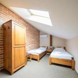 a bedroom with two beds and a skylight at Vinatus Pince in Villány