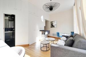 a living room with a couch and a table at Residence central marais in Paris