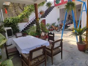 a table and chairs in a courtyard with a staircase at Ram Madaiya Home stay in Faizābād