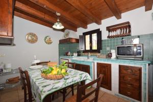 a kitchen with a table with a bowl of fruit on it at Mythos Holidays & Events in Siracusa