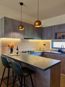 a kitchen with a island with a counter and two chairs at Apartment Mate in Pridraga