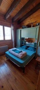 a bedroom with a large bed in a wooden room at Logement cosy au pied des pistes in Saint-Pierre-dels-Forcats