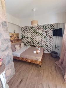a bedroom with a bed and a wall with flowers at IL TRAMONTO APARTMENT 1 in Kanali