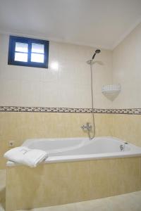 a bath tub in a bathroom with a window at GALIHOST - Casa da Sobreira in Meis +24 photos