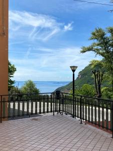 a balcony with a fence and a view of the ocean at Ca' ai Tigli in Tignale