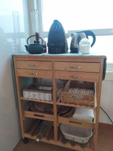 a wooden cabinet with dishes on top of it at O Recuncho de Belén in Baiona