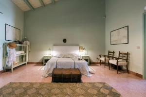 a bedroom with a bed with a suitcase on the floor at Masseria Baroni in Casa Bonivini +47 photos