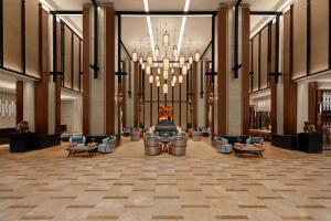 a large lobby with a large chandelier and chairs at Chiang Mai Marriott Hotel in Chiang Mai