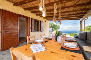 jadalnia ze stołem i widokiem na ocean w obiekcie Sa Domo Isola Rossa w mieście Trinità dʼAgultu