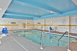 a large swimming pool with blue ceilings at Fairfield Inn & Suites by Marriott Madison West/Middleton in Madison