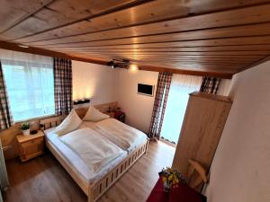 una camera con letto e soffitto in legno di Pension Sydler a Bad Goisern