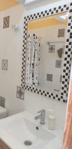 a bathroom with a sink and a mirror at Casa Faican in Agaete +25 photos
