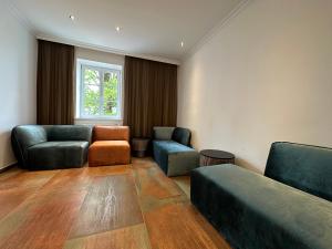 um quarto com duas cadeiras, um sofá e uma janela em das zellersee em Zell am See