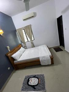 a bedroom with a bed with a window and a rug at Villa 2 chambres salon in Abomey-Calavi