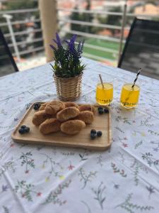 a cutting board with cookies and two glasses of orange juice at Apartments Romano in Dubrovnik