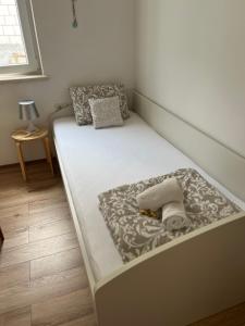 a bed in a small room with at Apartments Romano in Dubrovnik